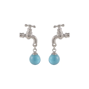 Detail view of creative silver faucet earrings with a translucent blue crystal drop charm
