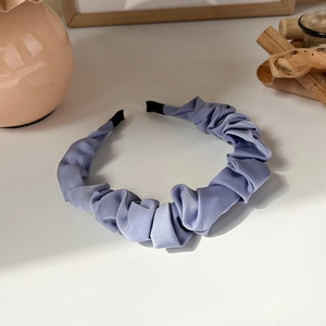 Detail of lavender satin pleated cloud headband with protective black end caps