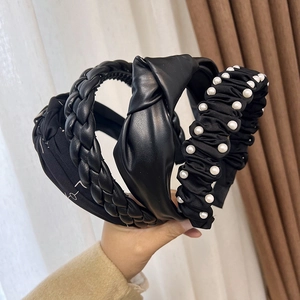 Elegant 4-piece black headband set with pearls, braided leather, and knotted fabric styles