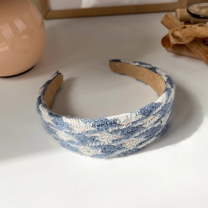Detailed close-up of blue and white knitted headband with non-slip inner lining