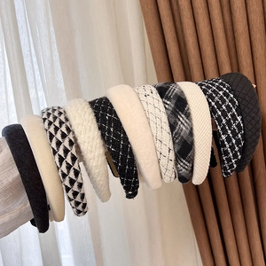 Close-up of assorted plaid and tweed wide headbands with textured fabric details