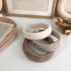 Gros plan de bandeaux épais en éponge pelucheuse en crème, gris et kaki à texture douce