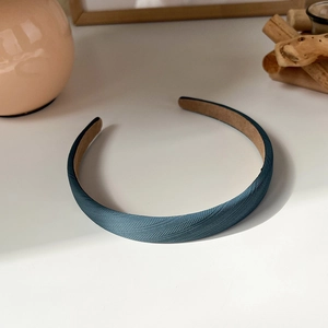 Detailed macro shot of dark blue herringbone weave headband with non-slip suede inner lining