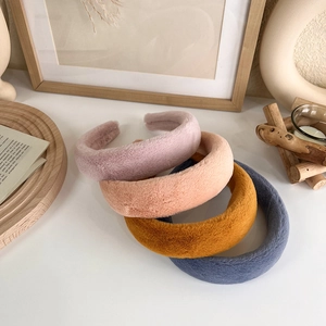 Détail de quatre serre-têtes épais en peluche aux couleurs douces de Morandi