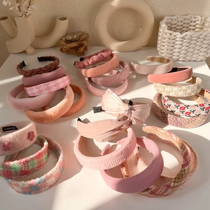 Detail of plush sponge headbands in various colors with handmade label and soft textures