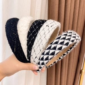 Close-up of five elegant French style tweed headbands in black and white patterns