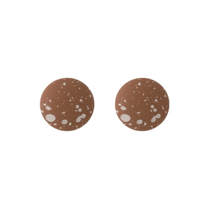 Detailed close-up of round brown stud earrings with white speckled artistic pattern