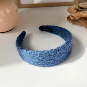 Detail showing the 'Hand Made' label on the soft blue knitted mohair-style headband