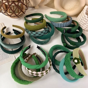 Assorted green vintage padded headbands in various knit textures and checkered patterns