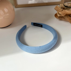 Detailed view of handmade light blue padded headband with a textured fabric finish