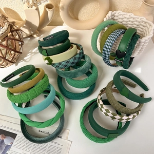 Detail showing various green headbands in velvet, corduroy, and knitted textures