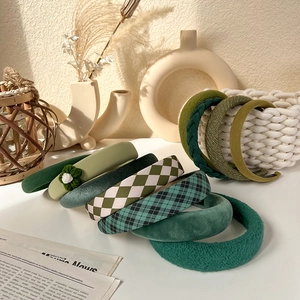 Detailed collection of vintage green fabric headbands in various knit and velvet textures
