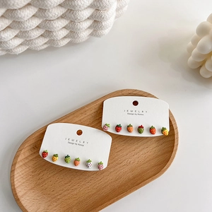 Cute strawberry stud earring set with multiple colors on a card display for women