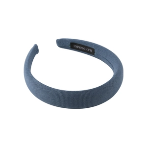 Thick Klein blue sponge headband with handmade label and high-top knitted texture