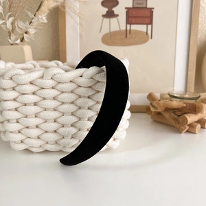 Detail of a thick black velvet padded headband on a decorative woven basket