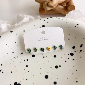 Detailed view of six mini cactus stud earrings with colorful enamel and zircon accents
