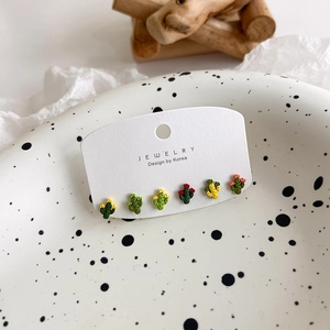 Detail view of colorful cactus stud earring set displayed on a white branded card