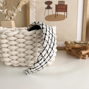 Detail of a padded headband with black and white houndstooth tweed texture on a basket