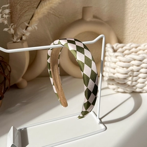 Detailed view of the vintage green checkered headband with a non-slip velvet inner lining