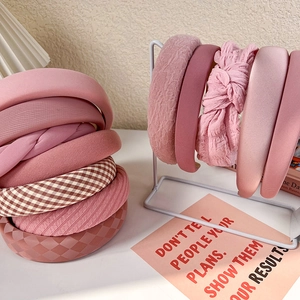Detailed collection of pink padded headbands with lace, plaid, and knotted fabric textures