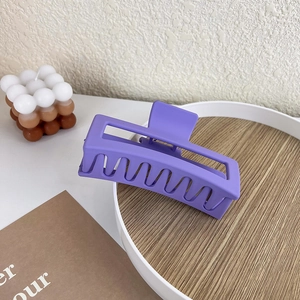 Close-up of matte purple square hair claw clip with frosted texture and sturdy teeth