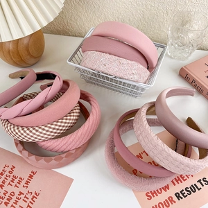Detailed close-up of pink headband set in satin, tweed and quilted styles for girls