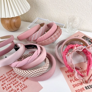 Detailed view of handmade pink padded headbands in various textures and fabrics