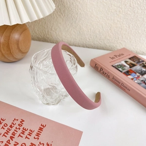 Detail shot of a sweet pink sponge headband showing twill fabric texture and non-slip lining