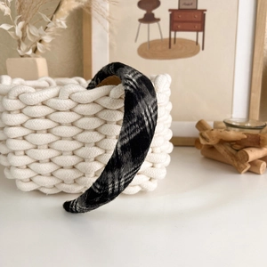 Detail shot of black and white plaid houndstooth padded headband with soft wool texture