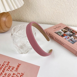 Detailed view of pink fabric headband with anti-slip beige lining for high-top styling