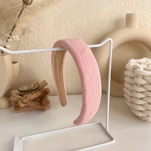 Detail of pink padded headband with heart pattern and anti-slip velvet lining