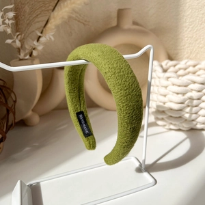 Detailed macro view of a handmade thick green sponge headband with soft plush texture