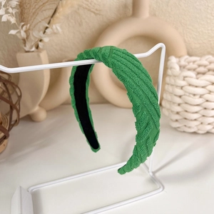 Detail of bright green textured sponge headband with diagonal weave and soft fabric