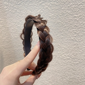 Close-up of dark brown fishtail braid headband showing realistic synthetic hair texture