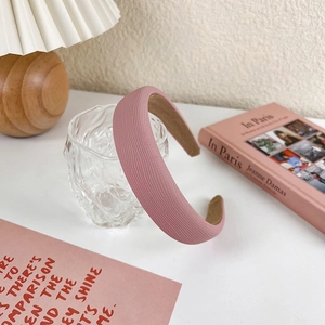 Detail showing soft pink ribbed fabric texture and non-slip lining on wide sponge headband