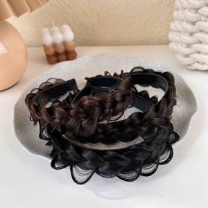 Detailed view of three fishbone braided headbands in brown and black with non-slip inner teeth