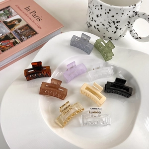 Set of 10 jelly color matte 4cm rectangular hollow hair claws displayed on a white plate