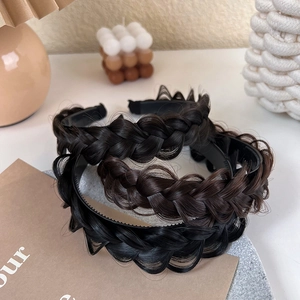 Detailed view of braided fishtail headband in black and dark brown synthetic hair