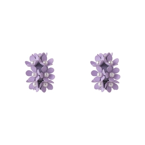 Close-up of matte purple flower earrings with pearl centers on white background