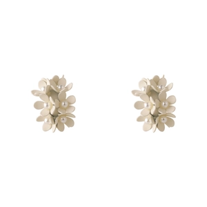 Close-up of matte white floral earrings with elegant small flowers and pearl centers