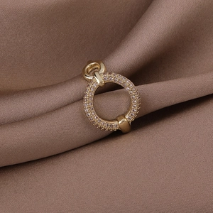 Detailed macro view of a gold round pendant encrusted with pavé pink sparkling crystals