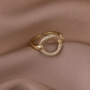 Elegant gold open ring with a hollow circle set with sparkling white zircons
