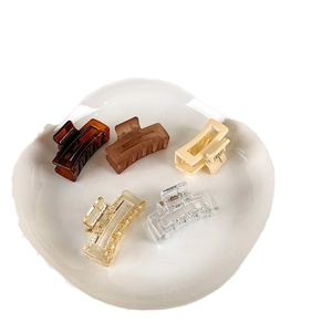 Five pieces of 4cm matte rectangular hair clips in jelly colors on a white ceramic tray
