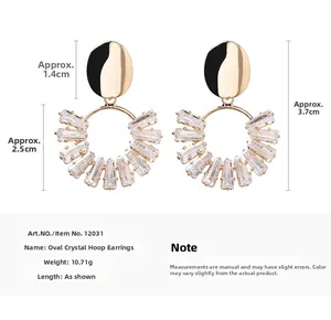 Macro detail of geometric gold earrings with crystal inlay and precise measurements