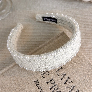 Detail of handmade cream tweed headband featuring white pearls and beads decoration