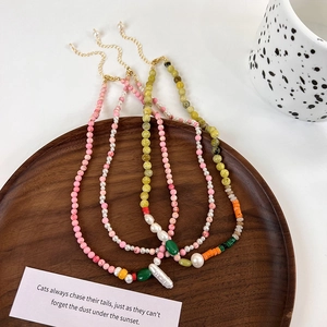 Detailed close-up of handmade freshwater pearl beaded necklaces in various pastel colors