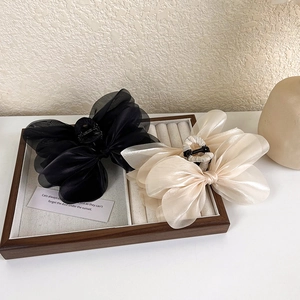 Elegant large fabric bow hair claws in black and champagne mesh for thick hair