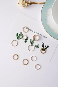 Set of ten gold-toned minimalist rings in various designs on a white aesthetic background