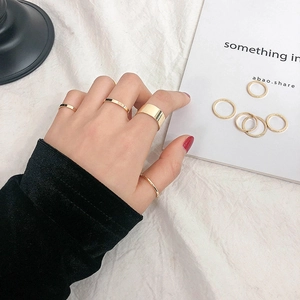 Minimalist 10-piece gold ring set for women with various smooth widths on a white background