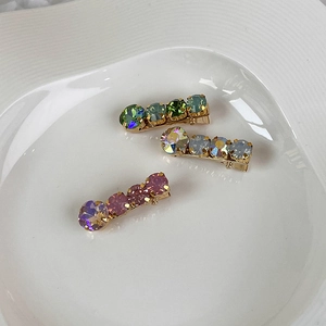 Three-piece set of cream-colored rhinestone hair clips with colorful crystals and gold metal